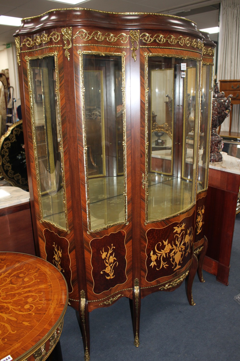 A Meuble Francais marquetry inlaid bowfront vitrine, W.124cm D.52cm H.177cm